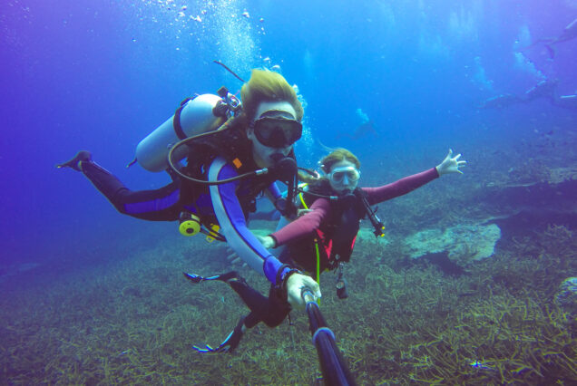Professional diving instructor giving safety briefing before Red Sea dive